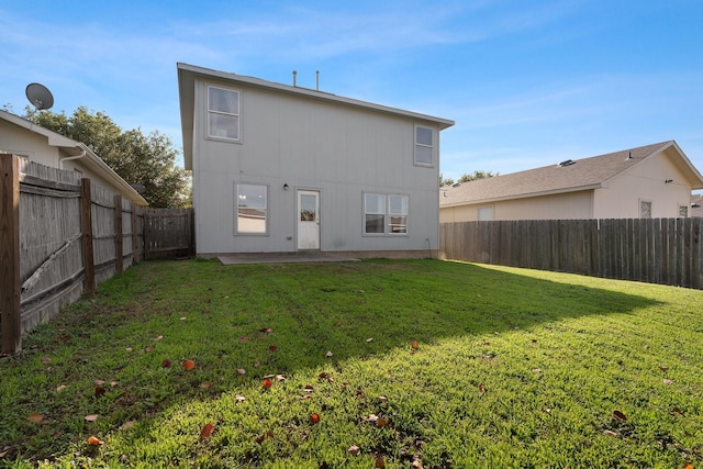 back of property with a patio and a lawn