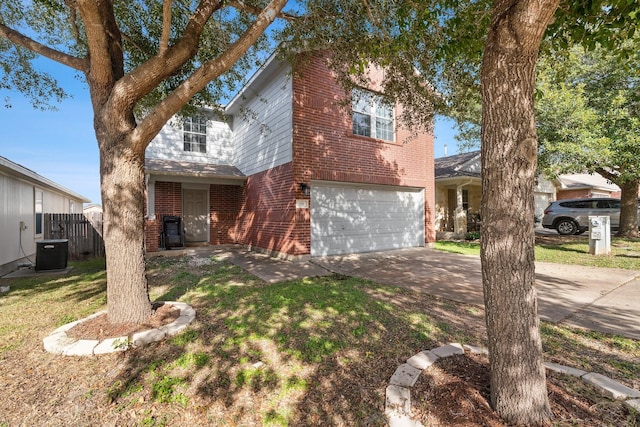 view of front property featuring central AC, a garage, and a front yard