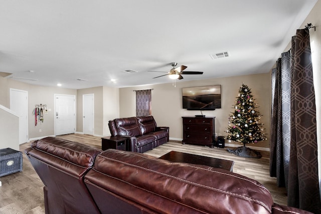 living room with ceiling fan and light hardwood / wood-style flooring