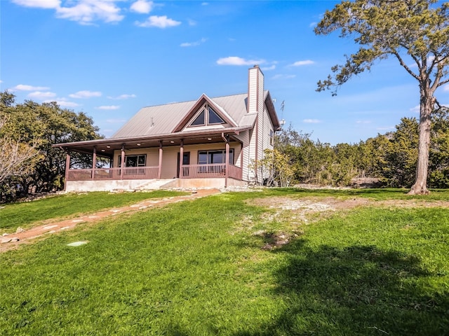 rear view of house with a lawn and covered porch