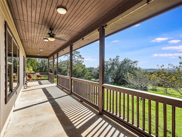 deck featuring a lawn and ceiling fan