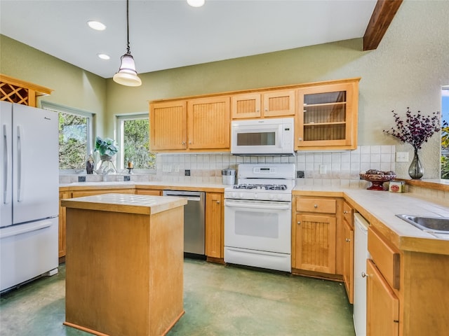 kitchen featuring white appliances, decorative light fixtures, concrete flooring, and a center island