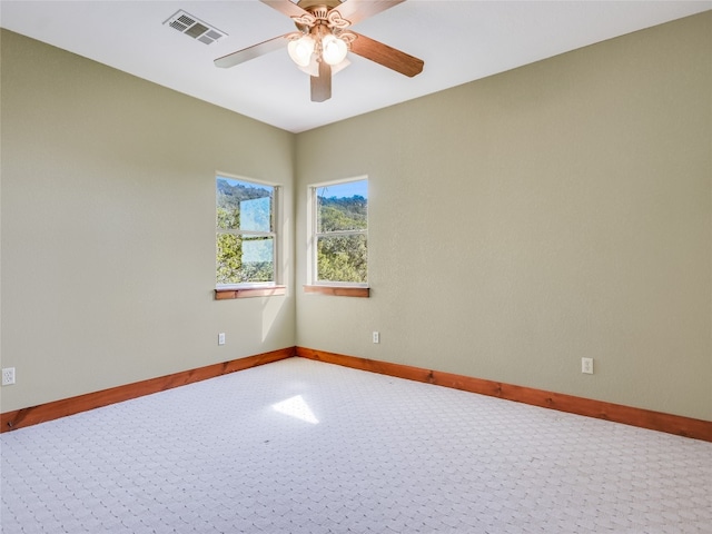 carpeted empty room featuring ceiling fan