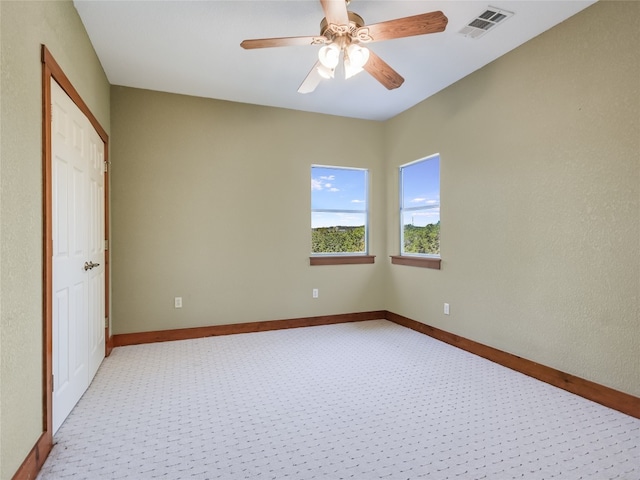 interior space featuring light carpet and ceiling fan