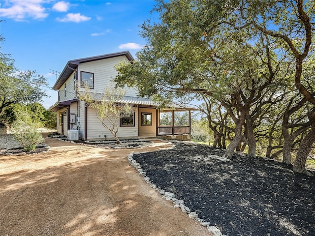 rear view of property featuring central AC unit