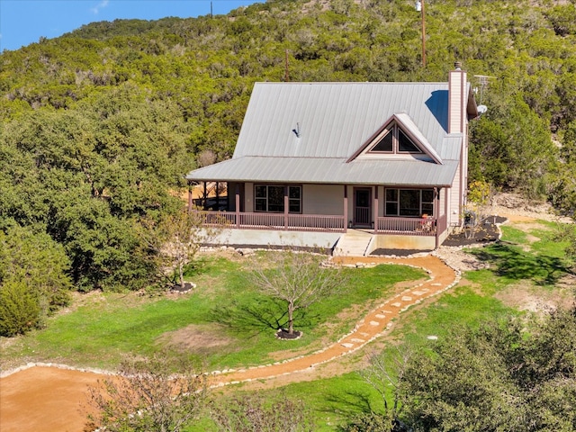 rear view of property featuring covered porch