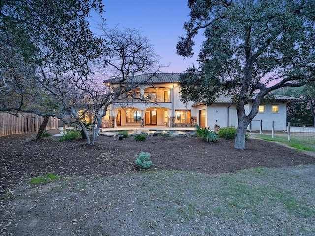 view of front of house featuring a balcony and a patio area