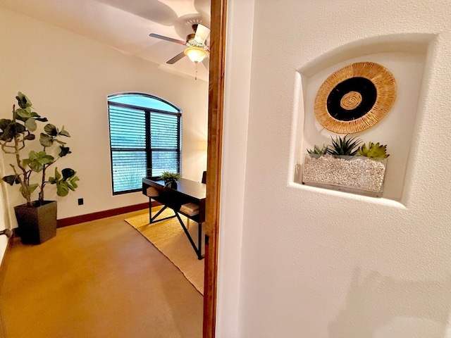 carpeted home office with ceiling fan