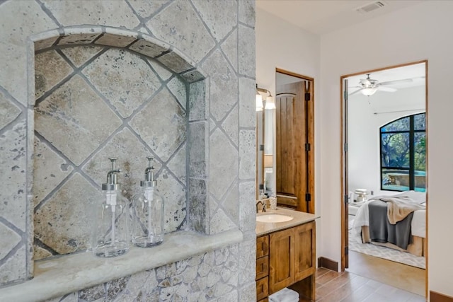 bathroom featuring wood-type flooring, vanity, and a shower