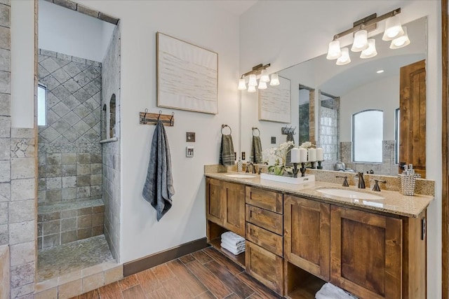 bathroom featuring vanity and tiled shower