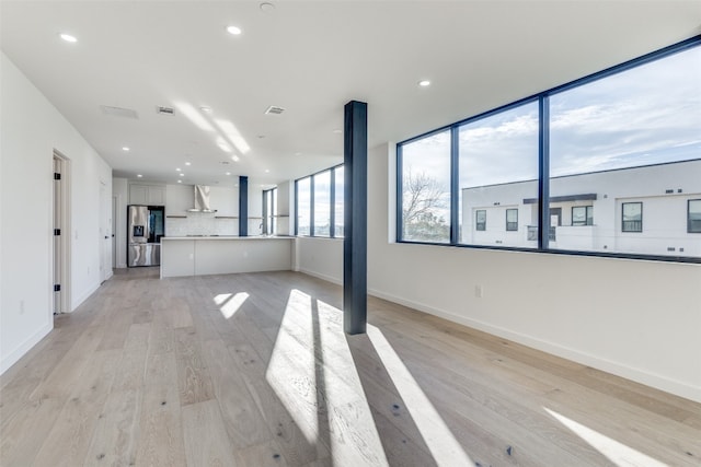 spare room with light hardwood / wood-style flooring