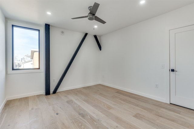 empty room featuring ceiling fan and light hardwood / wood-style floors