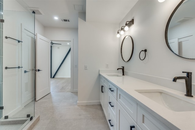 bathroom featuring vanity and a shower with shower door