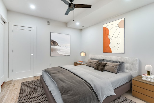 bedroom with ceiling fan and light hardwood / wood-style floors