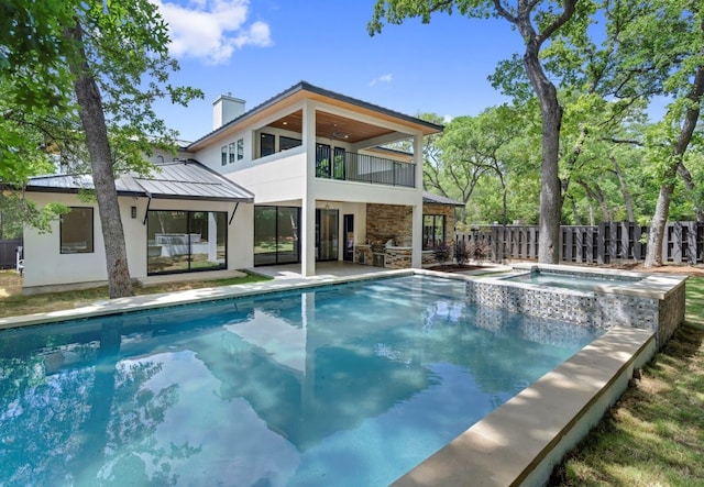 view of swimming pool featuring a patio area and an in ground hot tub