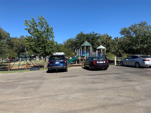 view of parking with a playground