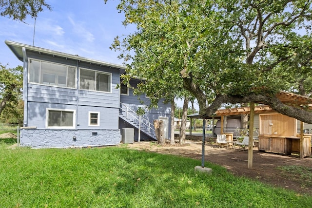 rear view of property with a lawn