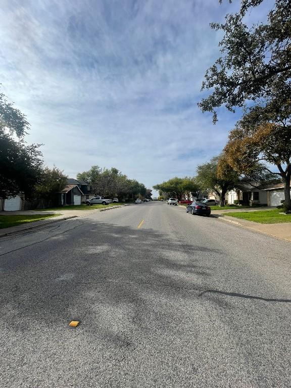 view of road with sidewalks and curbs