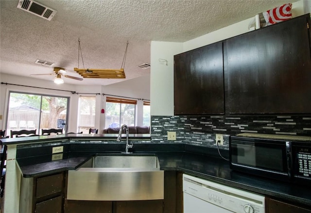 kitchen featuring a sink, visible vents, and white dishwasher