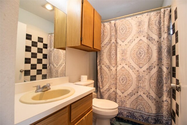 bathroom featuring curtained shower, toilet, and vanity