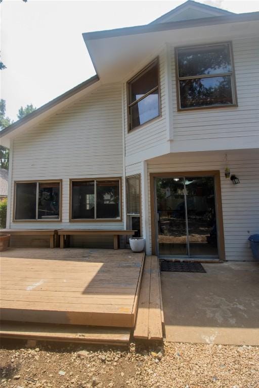 back of house with a wooden deck