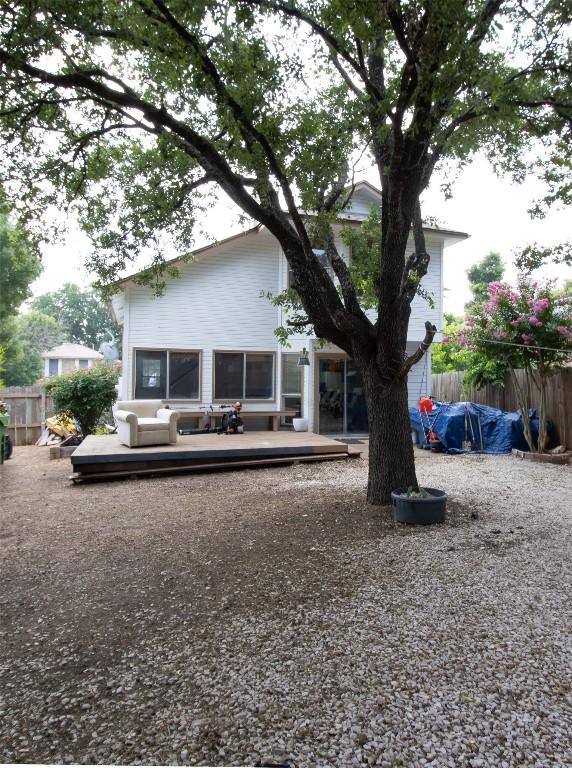 back of property featuring a wooden deck and fence