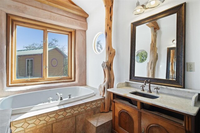 bathroom with vanity and a relaxing tiled tub