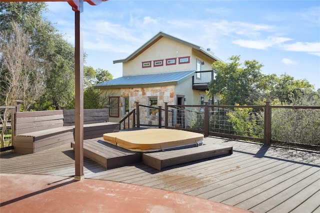 wooden terrace featuring a covered hot tub