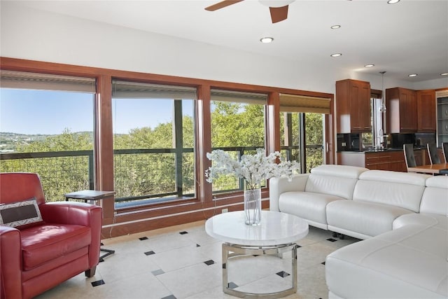 living room featuring sink and ceiling fan