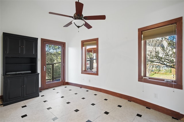 foyer featuring a wealth of natural light, ceiling fan, and light tile patterned floors