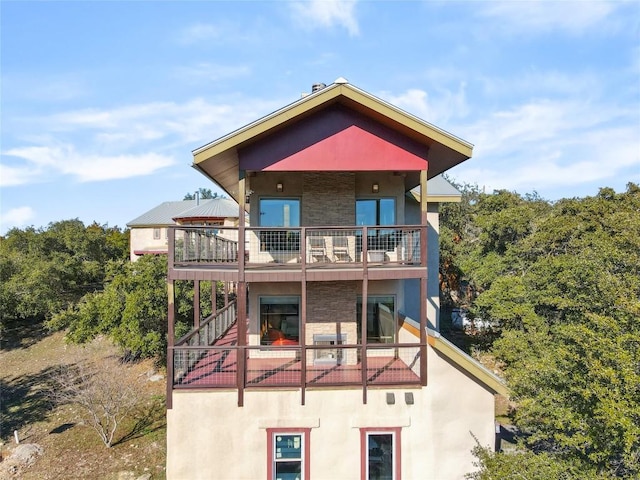 rear view of house with a balcony