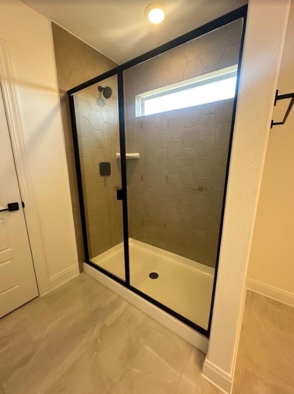 bathroom with a shower with shower door