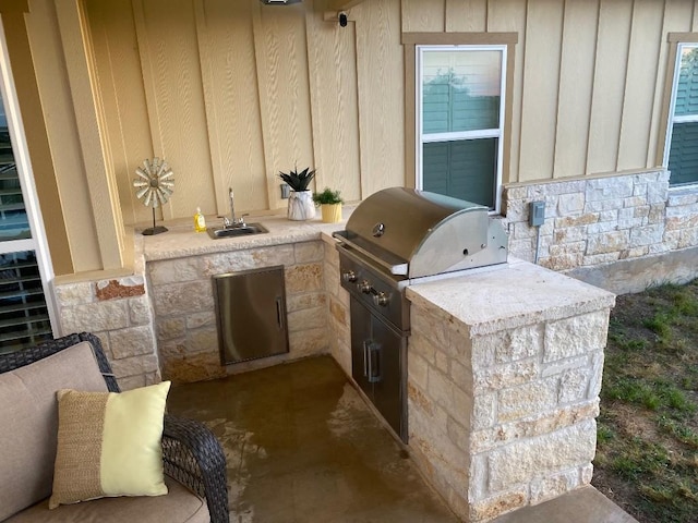 view of patio featuring grilling area, a sink, and area for grilling