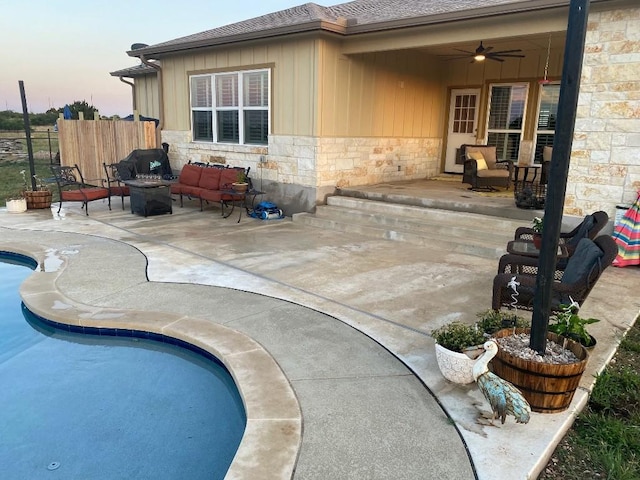 view of pool with ceiling fan, fence, an outdoor living space, a fenced in pool, and a patio area