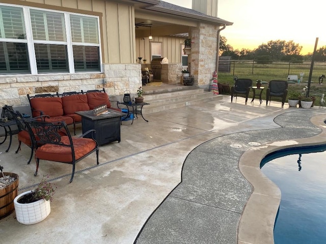 view of patio featuring fence, an outdoor hangout area, and a fenced in pool