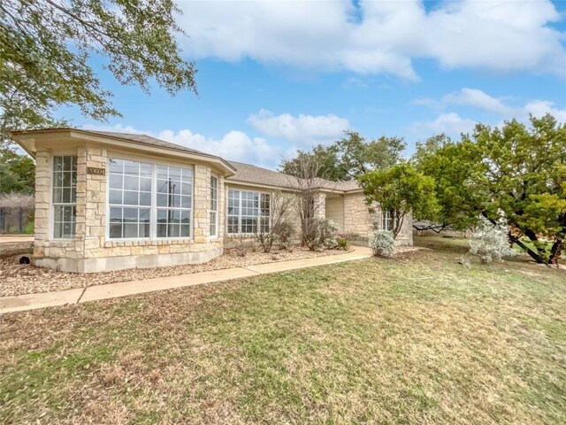 rear view of property featuring a yard