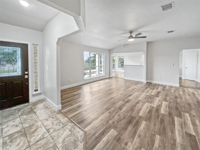 foyer entrance featuring lofted ceiling, ceiling fan, and light hardwood / wood-style floors