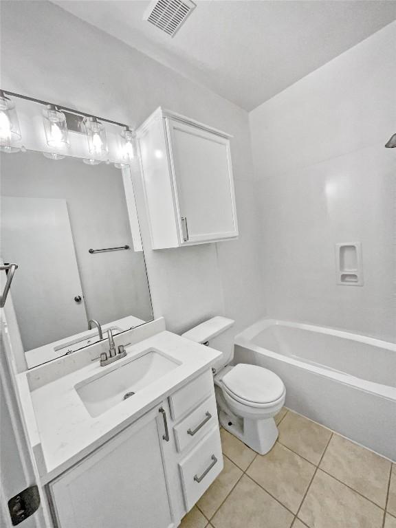 full bathroom featuring vanity, toilet, tile patterned flooring, and shower / bathing tub combination