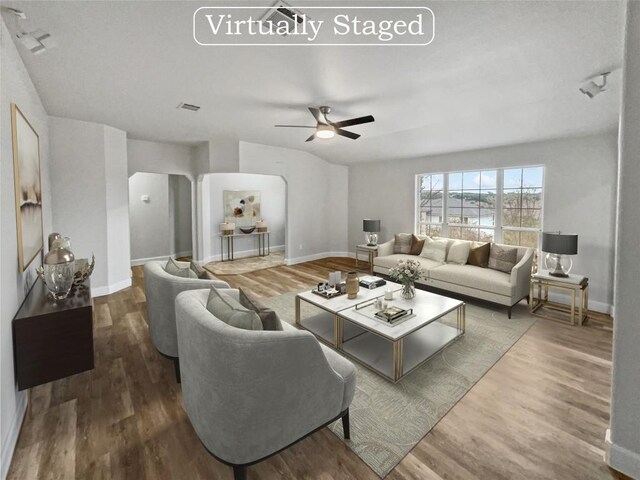 living room featuring hardwood / wood-style flooring and ceiling fan