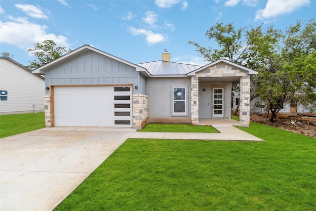 view of front of home with a front yard and a garage