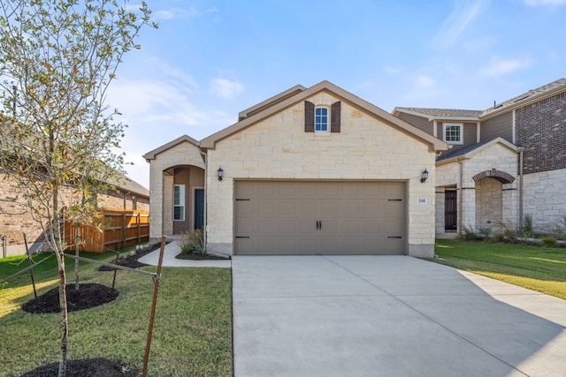 view of front of property with a front yard and a garage