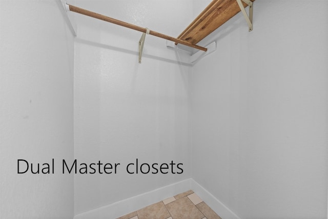 spacious closet featuring light tile patterned floors