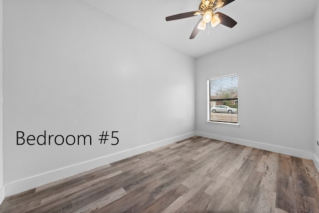 spare room with ceiling fan and hardwood / wood-style flooring