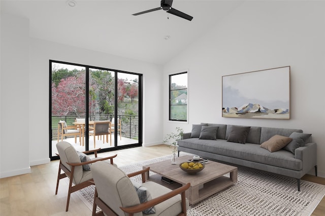 living room featuring light wood-type flooring, ceiling fan, and high vaulted ceiling