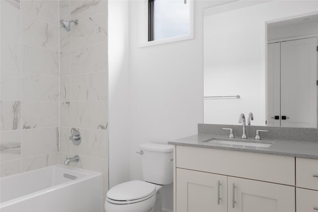 full bathroom with toilet, tiled shower / bath combo, and vanity