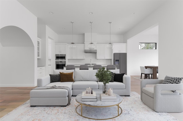 living room with sink and light hardwood / wood-style flooring