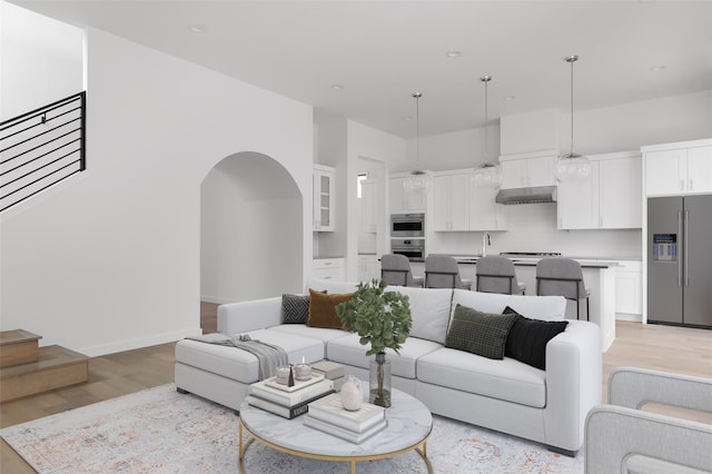 living room with sink and light hardwood / wood-style flooring