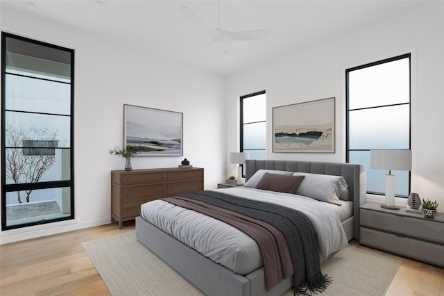 bedroom featuring ceiling fan and light hardwood / wood-style flooring