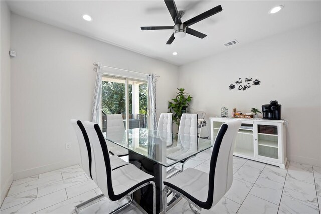 dining space featuring ceiling fan and light tile patterned floors