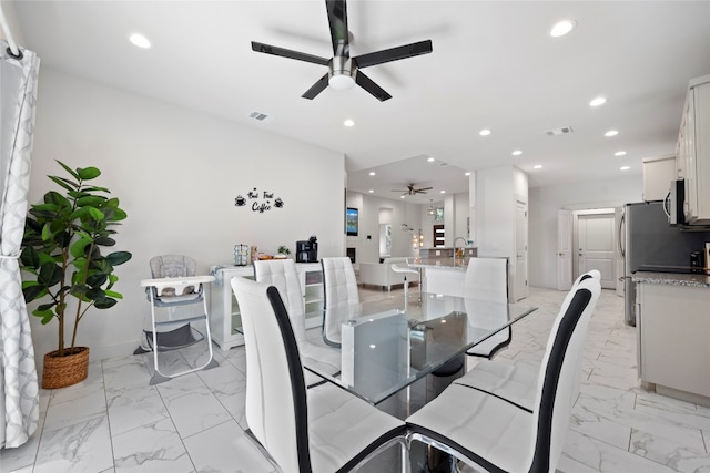 dining space featuring ceiling fan and light tile patterned flooring